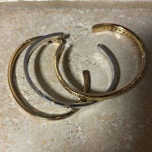 Tri-color (silver, gold and rose gold toned) open bangle bracelets.